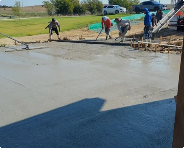 Concrete driveway with caution tape, showcasing a newly installed surface in front of a residential home.
