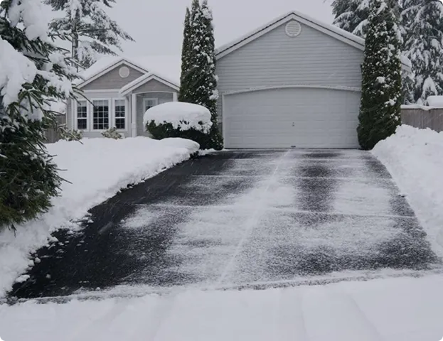 Concrete driveway with caution tape, showcasing a newly installed surface in front of a residential home.